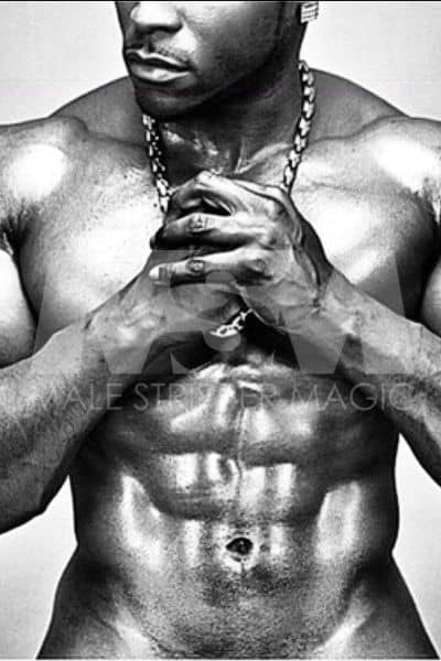 Black male stripper Onyx, black and white photo, oiled up, showing abs, wearing a chain