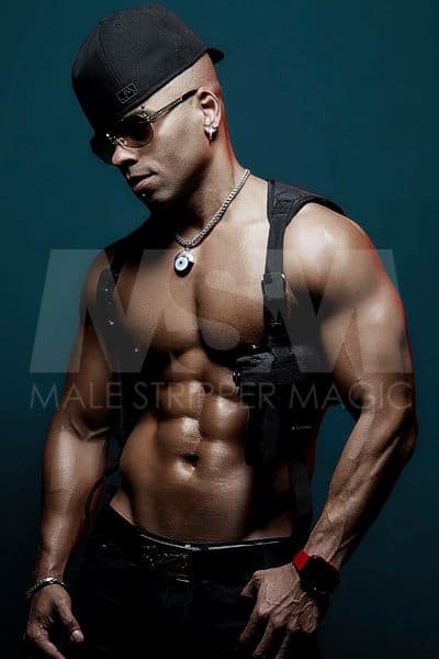 Male stripper Joey, fitted hat backwards, sunglasses, swat vest, showing abs