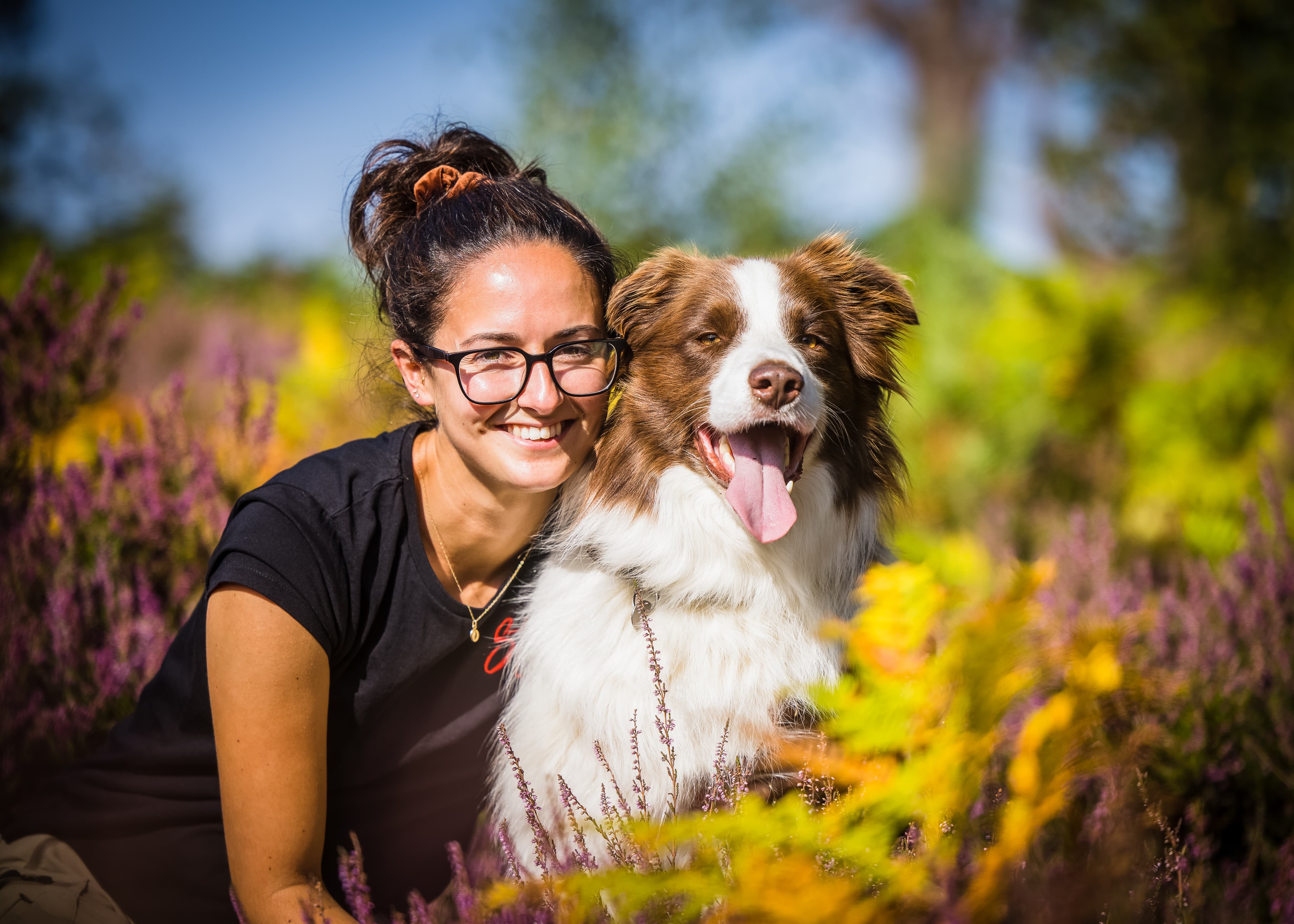 Stella smiling with a brown and white dog