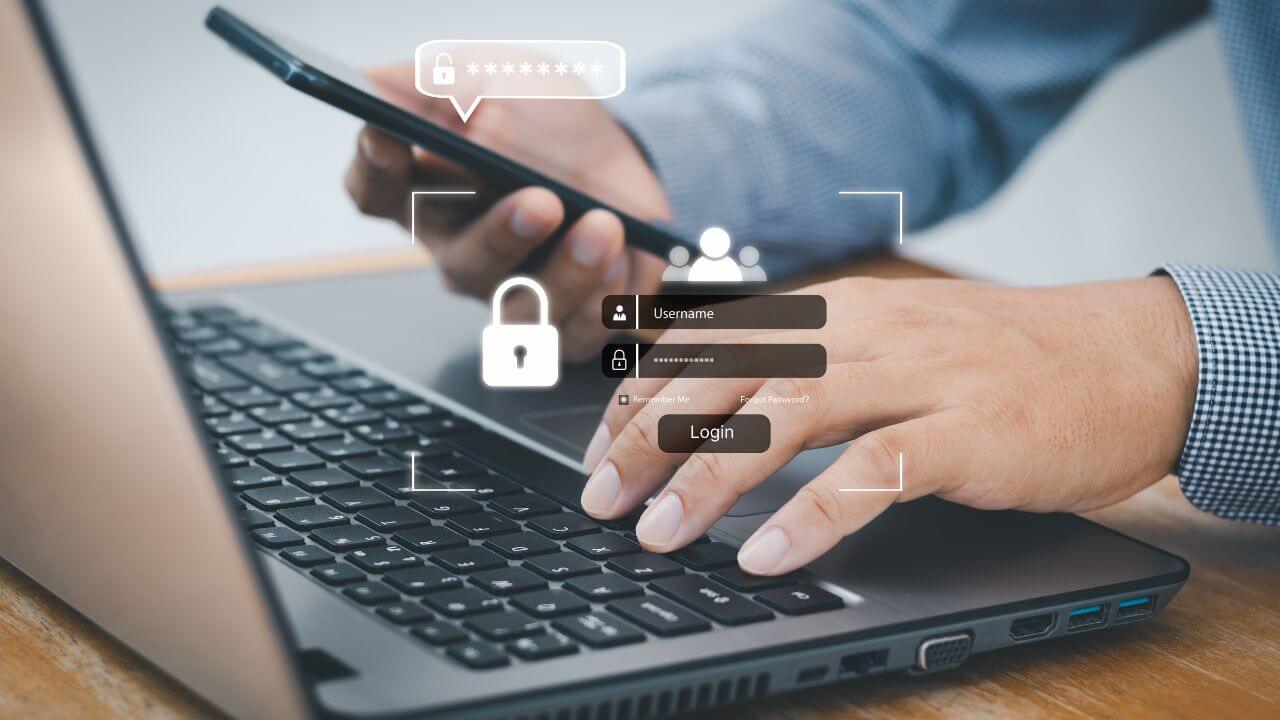 User logging into secure system with multi-factor authentication using phone and laptop for access control User logging into secure system with multi-factor authentication using phone and laptop for access control