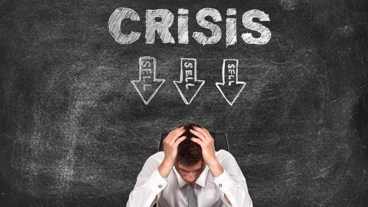 Stressed businessman in crisis with 'Sell' warnings, symbolizing IT risk from poor security decisions Stressed businessman in crisis with 'Sell' warnings, symbolizing IT risk from poor security decisions