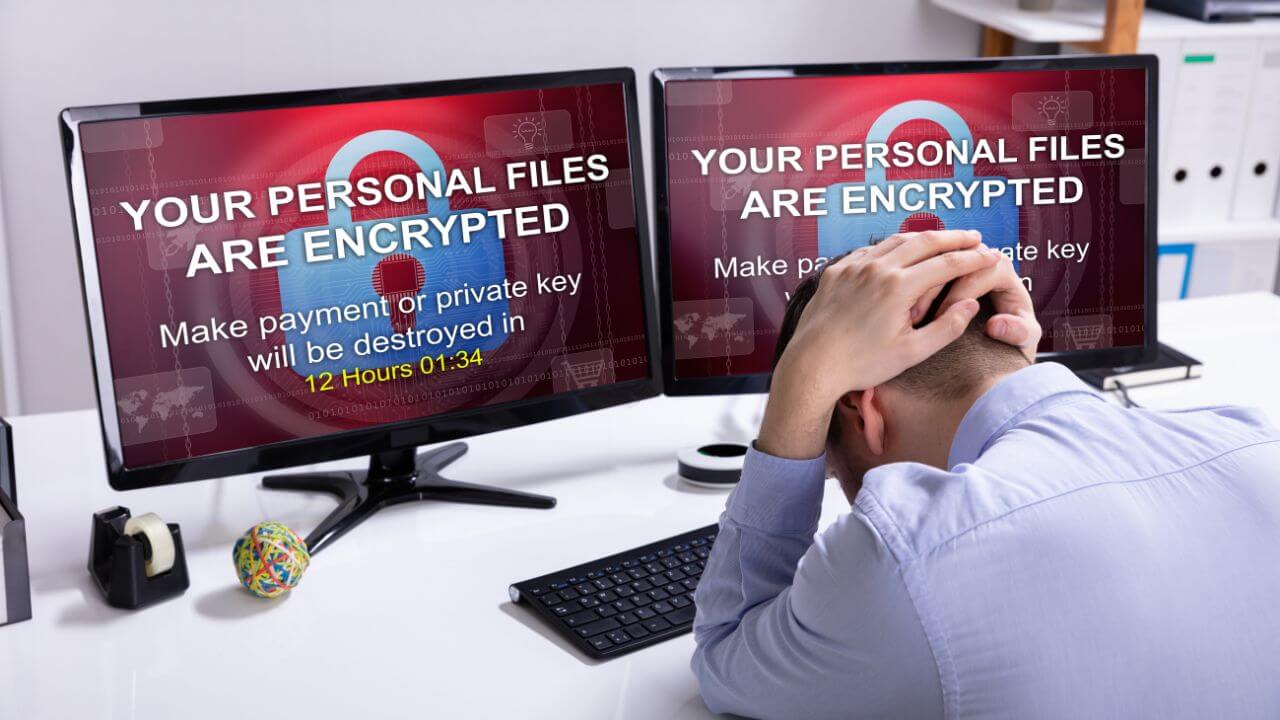 Dual monitors displaying ransomware message, illustrating a typical RaaS attack demanding payment. Dual monitors displaying ransomware message, illustrating a typical RaaS attack demanding payment.