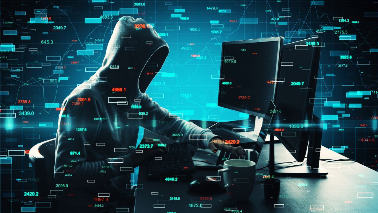 Hooded hacker at computer with floating code, depicting cybercriminal executing a RaaS operation. Hooded hacker at computer with floating code, depicting cybercriminal executing a RaaS operation.