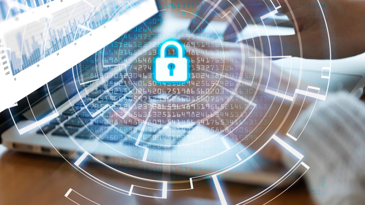 `Hands typing on laptop with padlock icon and data overlay, representing the start of secure digital infrastructure planning` `Hands typing on laptop with padlock icon and data overlay, representing the start of secure digital infrastructure planning`