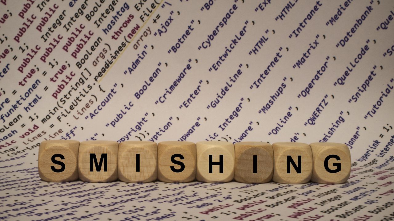 Word 'SMISHING' spelled out with wooden blocks over a background of cybersecurity and phishing-related terms Word 'SMISHING' spelled out with wooden blocks over a background of cybersecurity and phishing-related terms