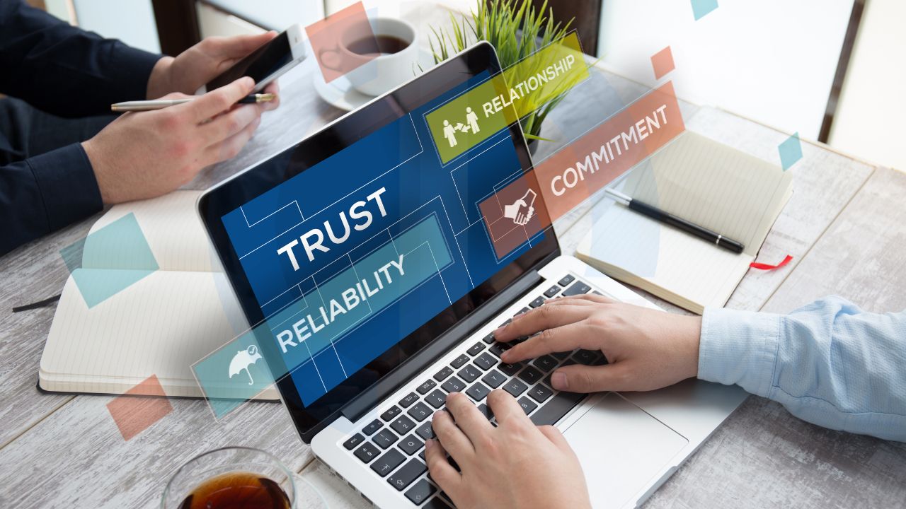 Hands on laptop with keywords like trust, reliability, relationship, and commitment representing smishing prevention by CyVent Hands on laptop with keywords like trust, reliability, relationship, and commitment representing smishing prevention by CyVent