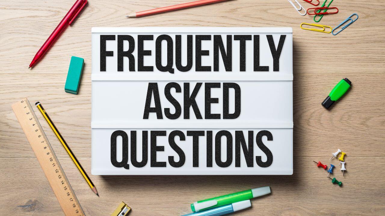 FAQ lightbox on wooden desk with office supplies, illustrating cybersecurity FAQs section FAQ lightbox on wooden desk with office supplies, illustrating cybersecurity FAQs section