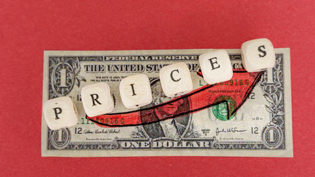 Penetration testing pricing concept with rising costs symbolized by cubes spelling 'prices' over a dollar bill Penetration testing pricing concept with rising costs symbolized by cubes spelling 'prices' over a dollar bill
