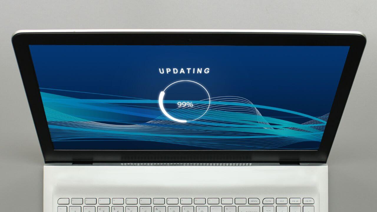 Laptop screen showing software update progress at 99%, symbolizing the importance of patch management. Laptop screen showing software update progress at 99%, symbolizing the importance of patch management.