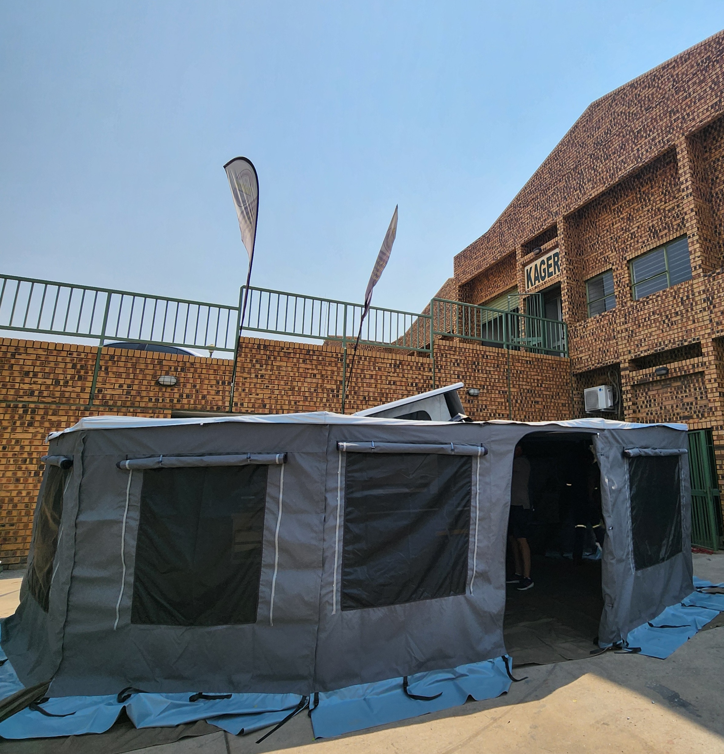UniPod MicroPod full camping setup with awning and outdoor gear
