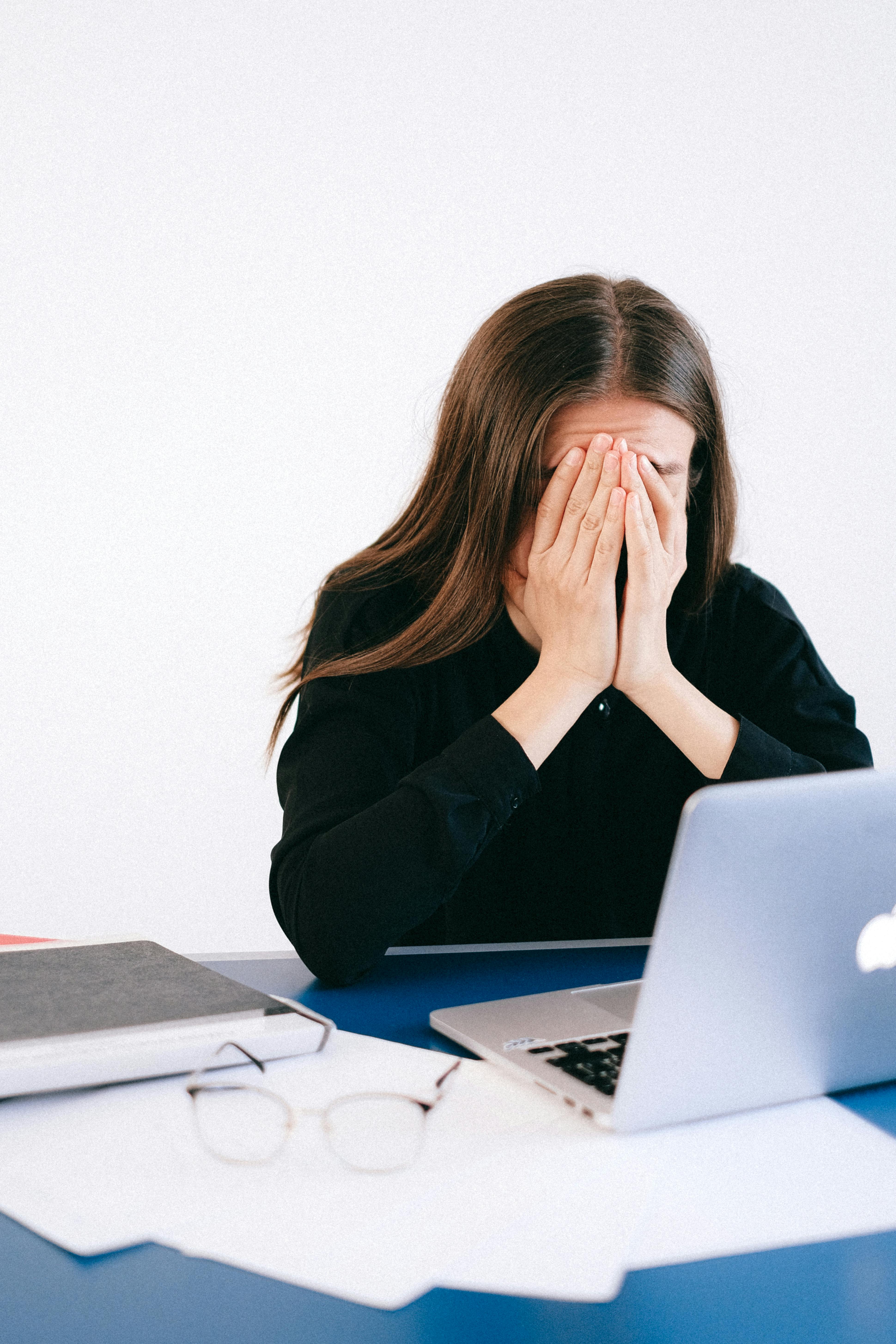 woman covering face laptop woman covering face laptop