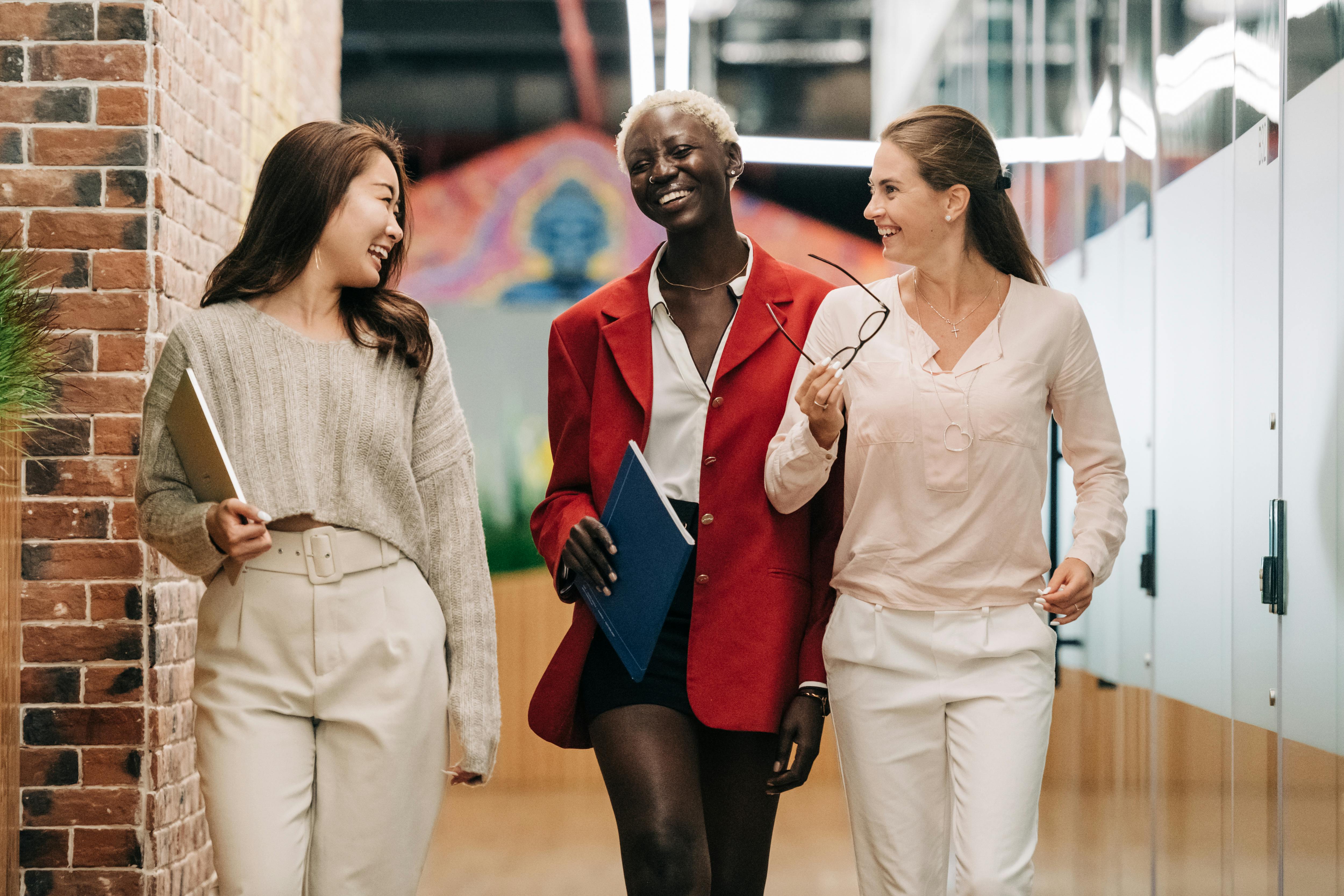 professional women smiling walking together professional women smiling walking together