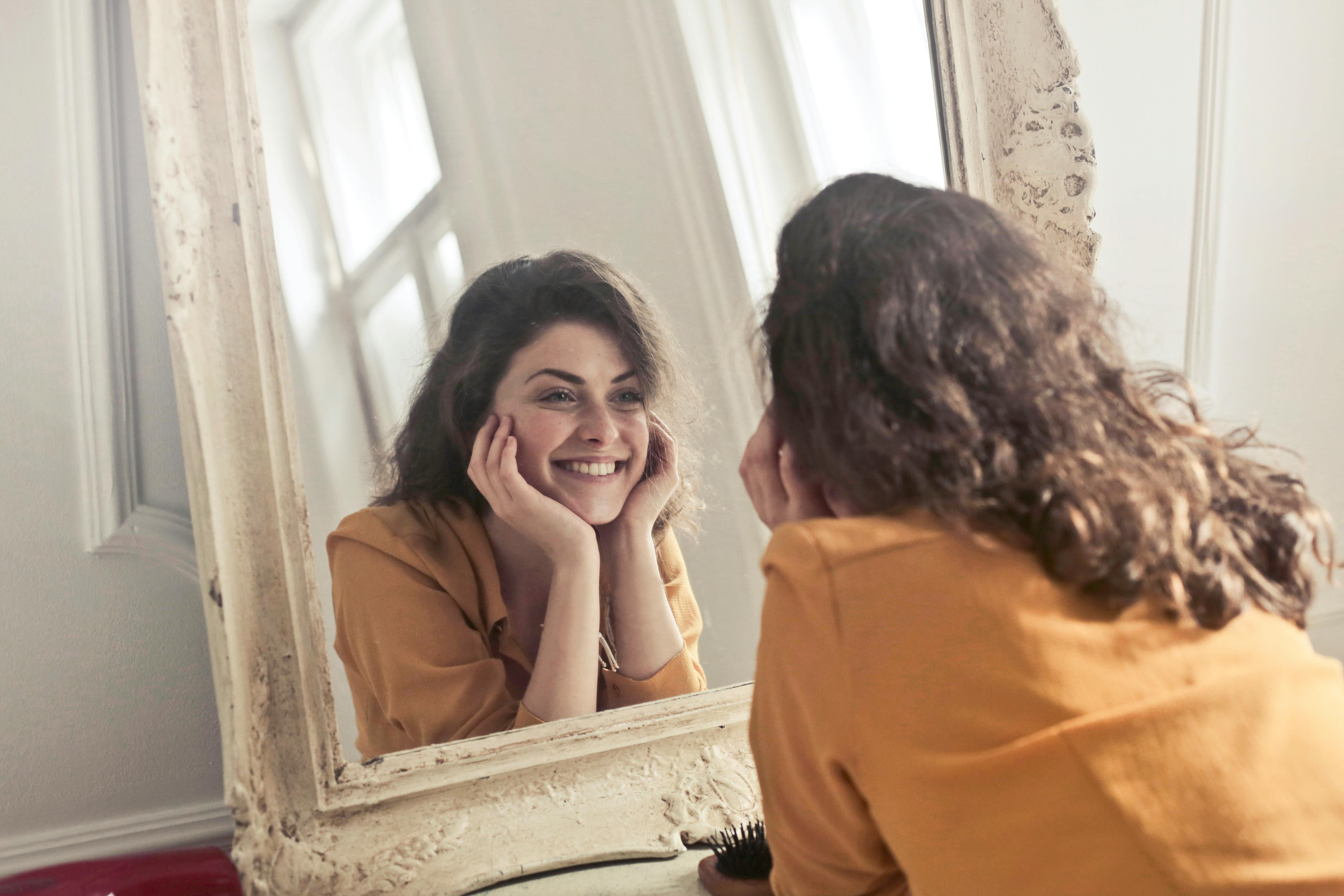 smiling woman in mirror smiling woman in mirror