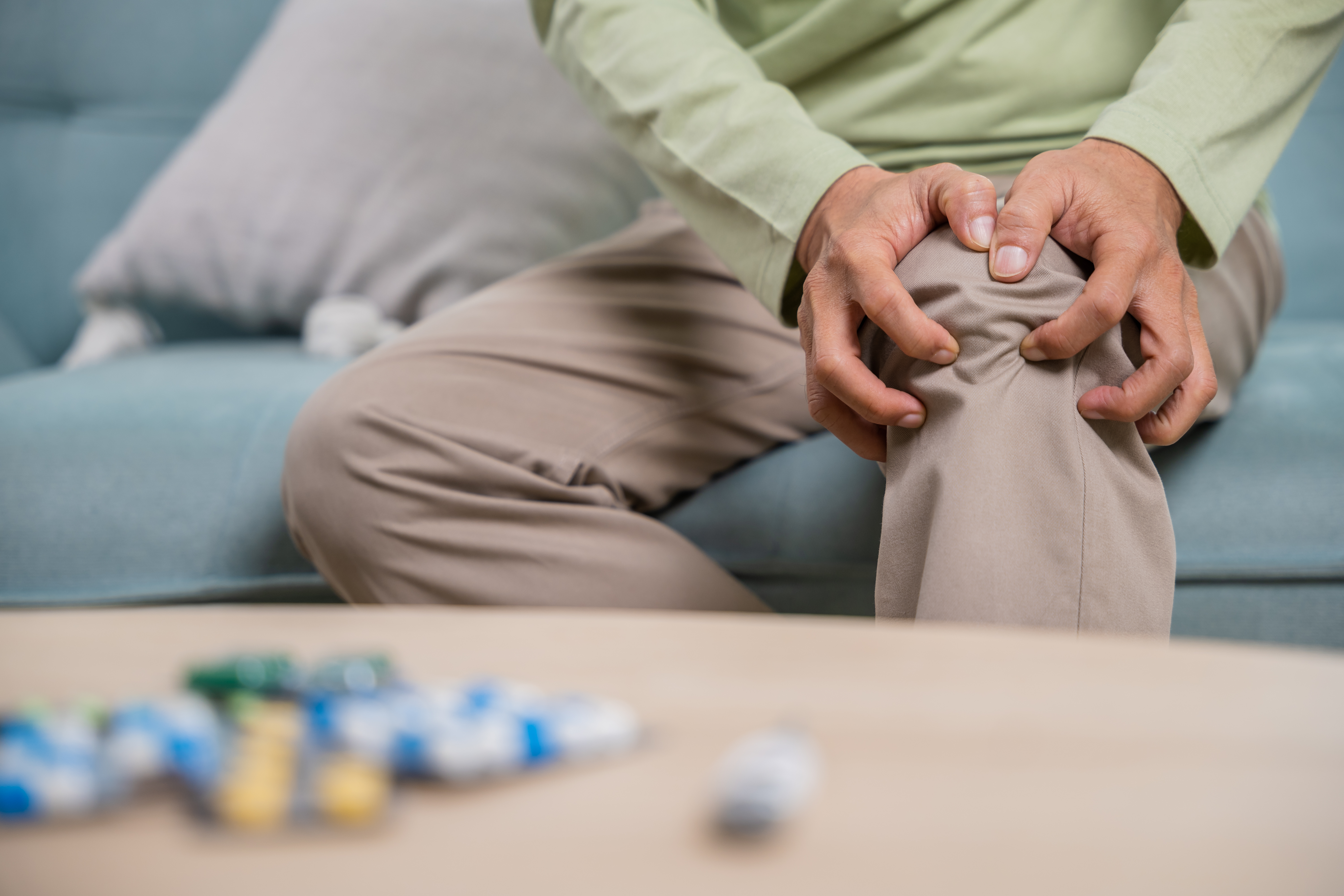 suffering from knee joint pain, medications on table suffering from knee joint pain, medications on table