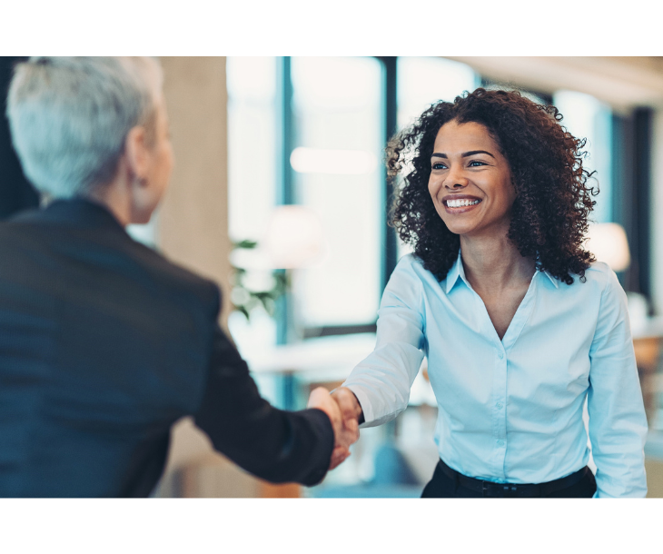 two business women shaking hands