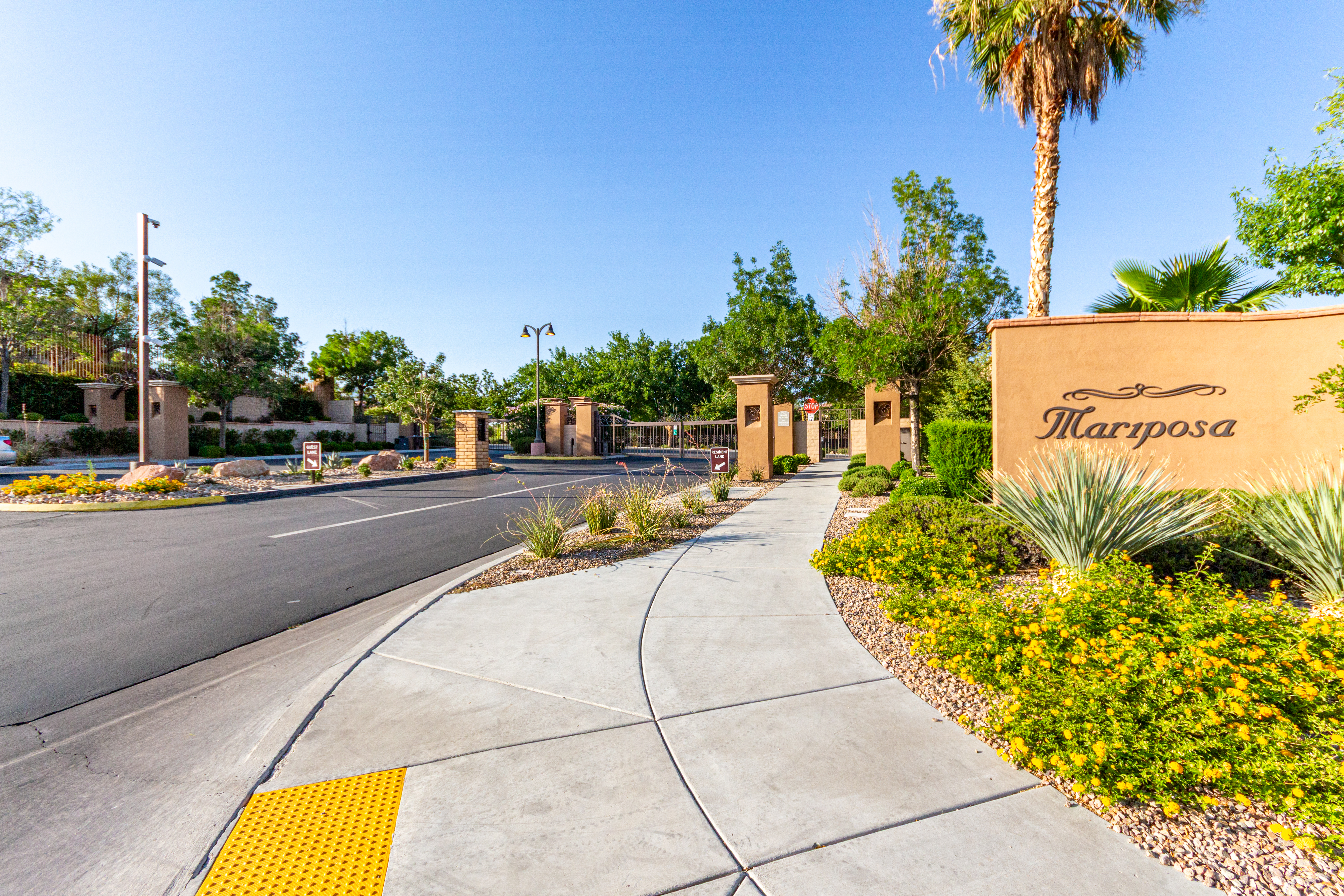 Gated entrance to Mariposa community in The Paseos, Summerlin Las Vegas — featuring manicured landscaping, palm trees, and upscale neighborhood signage. Gated entrance to Mariposa community in The Paseos, Summerlin Las Vegas — featuring manicured landscaping, palm trees, and upscale neighborhood signage.