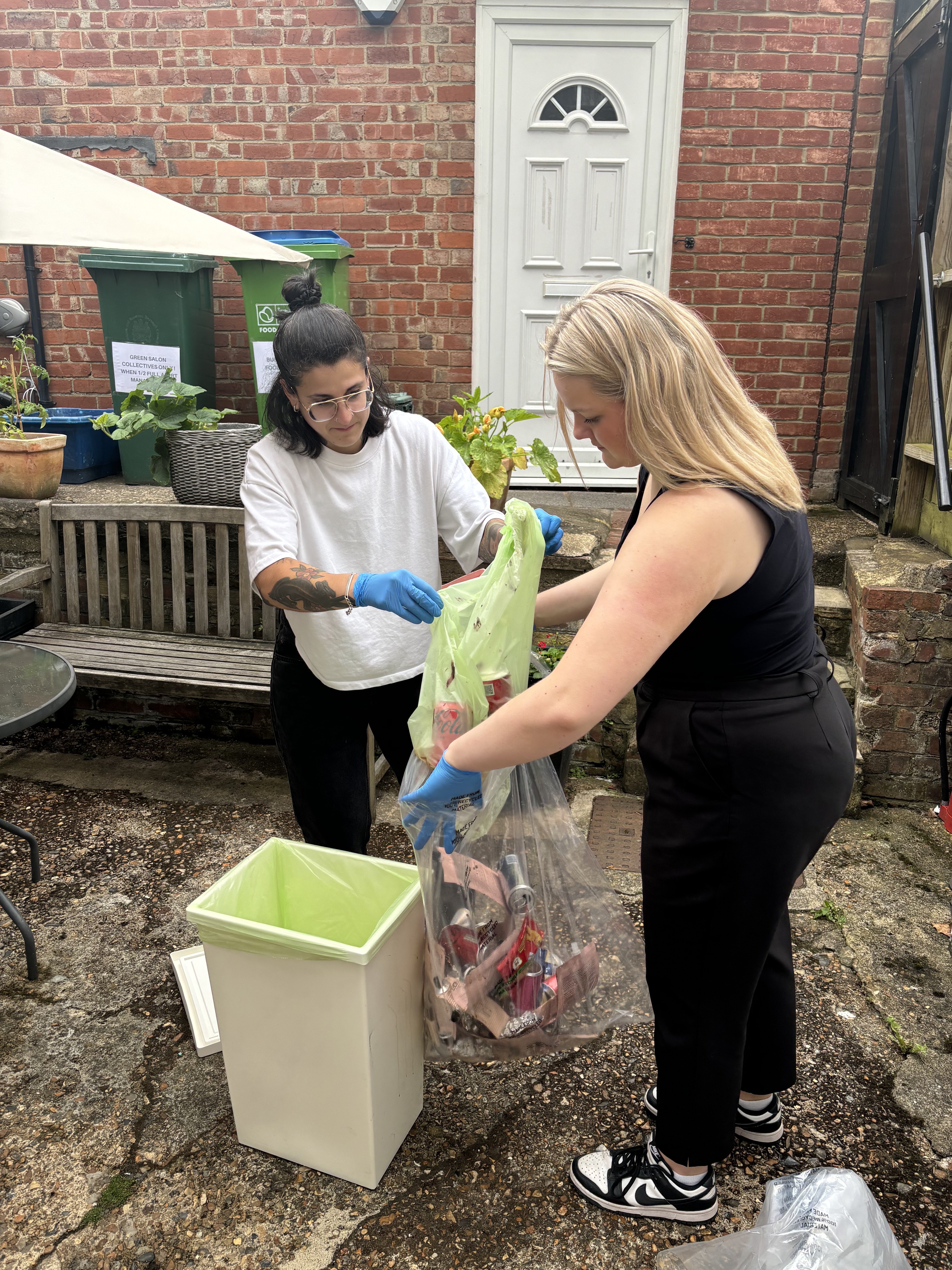 Recycling bins in sustainable salon garden showing eco-friendly waste management system Recycling bins in sustainable salon garden showing eco-friendly waste management system