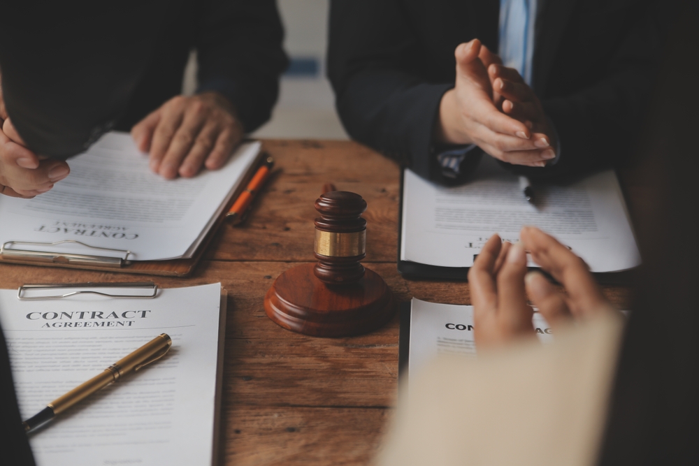 A stack of legal documents related to real estate wholesaling