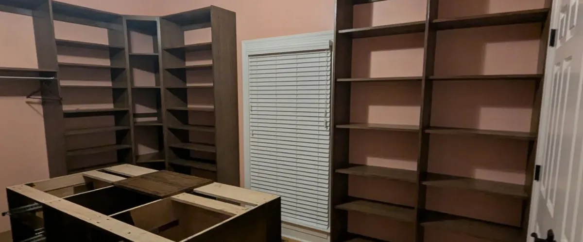 A walk-in closet with custom shelves and an open layout for organization and storage solutions A walk-in closet with custom shelves and an open layout for organization and storage solutions
