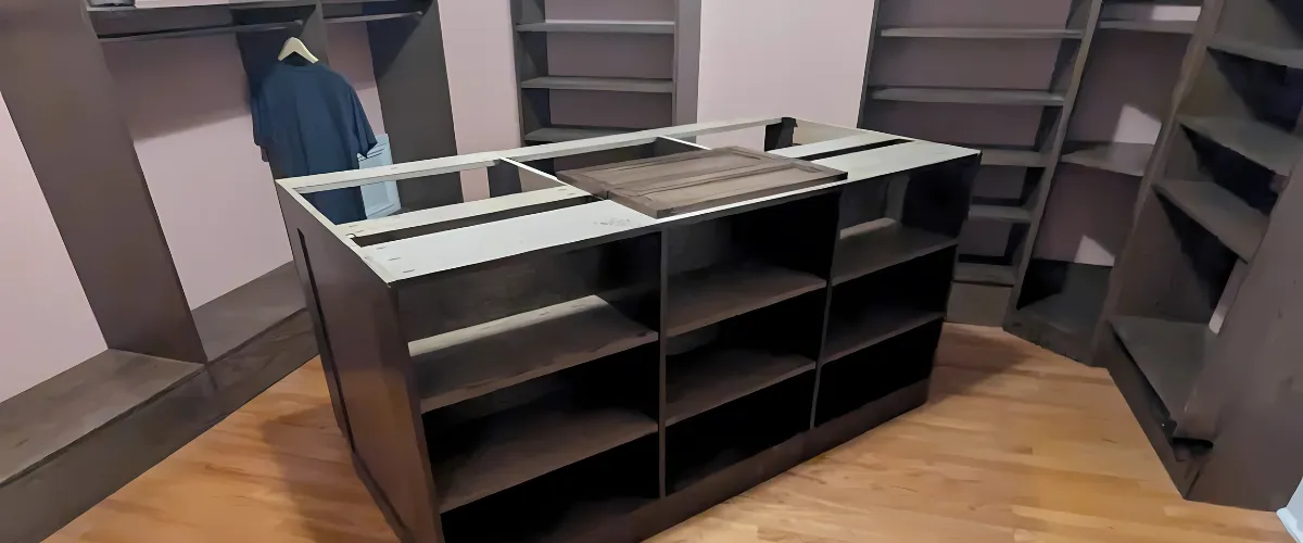 A custom storage shelf unit placed in a closet for neatly organized items and clothing. A custom storage shelf unit placed in a closet for neatly organized items and clothing.