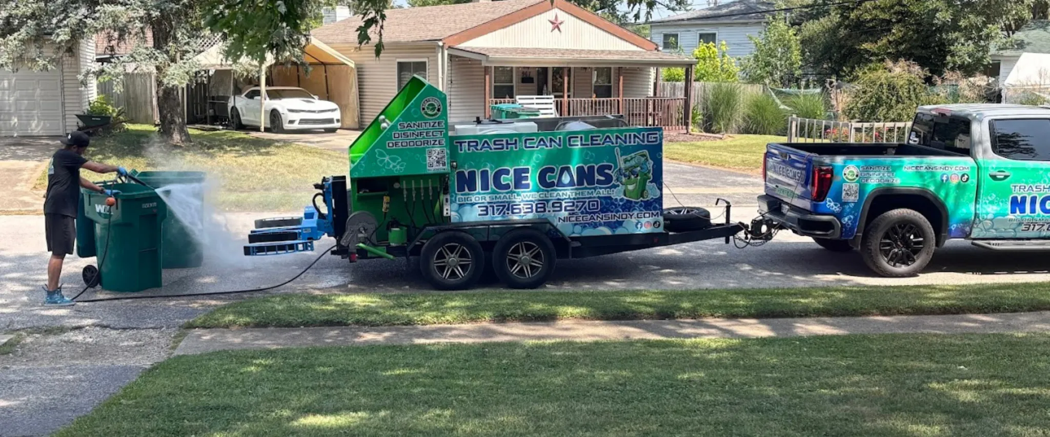 echnician power washing green trash bins using mobile cleaning equipment echnician power washing green trash bins using mobile cleaning equipment
