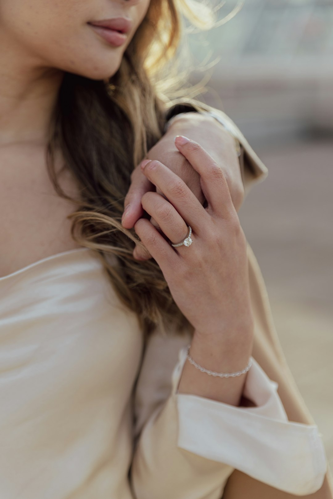 Woman holding man's arm with wedding ring