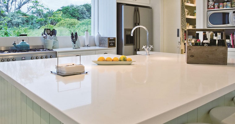 a white kitchen with a white countertop