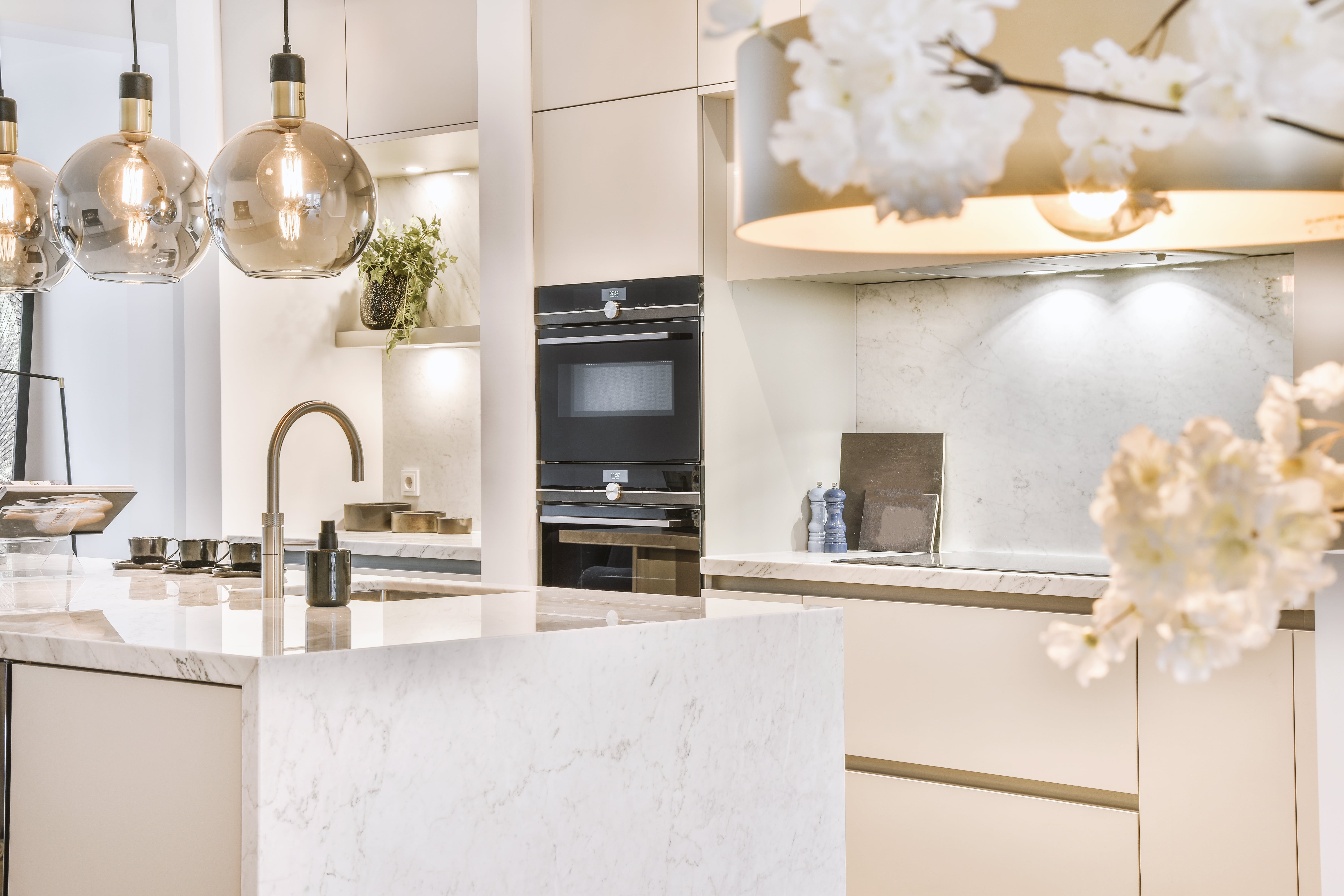 a kitchen with a white countertop and a white sink