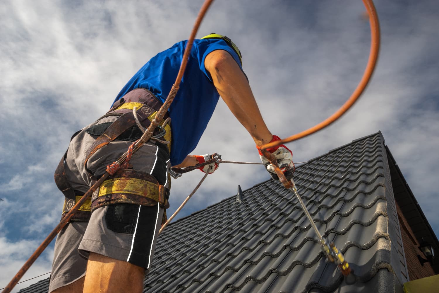 an expert contractor painting the roof