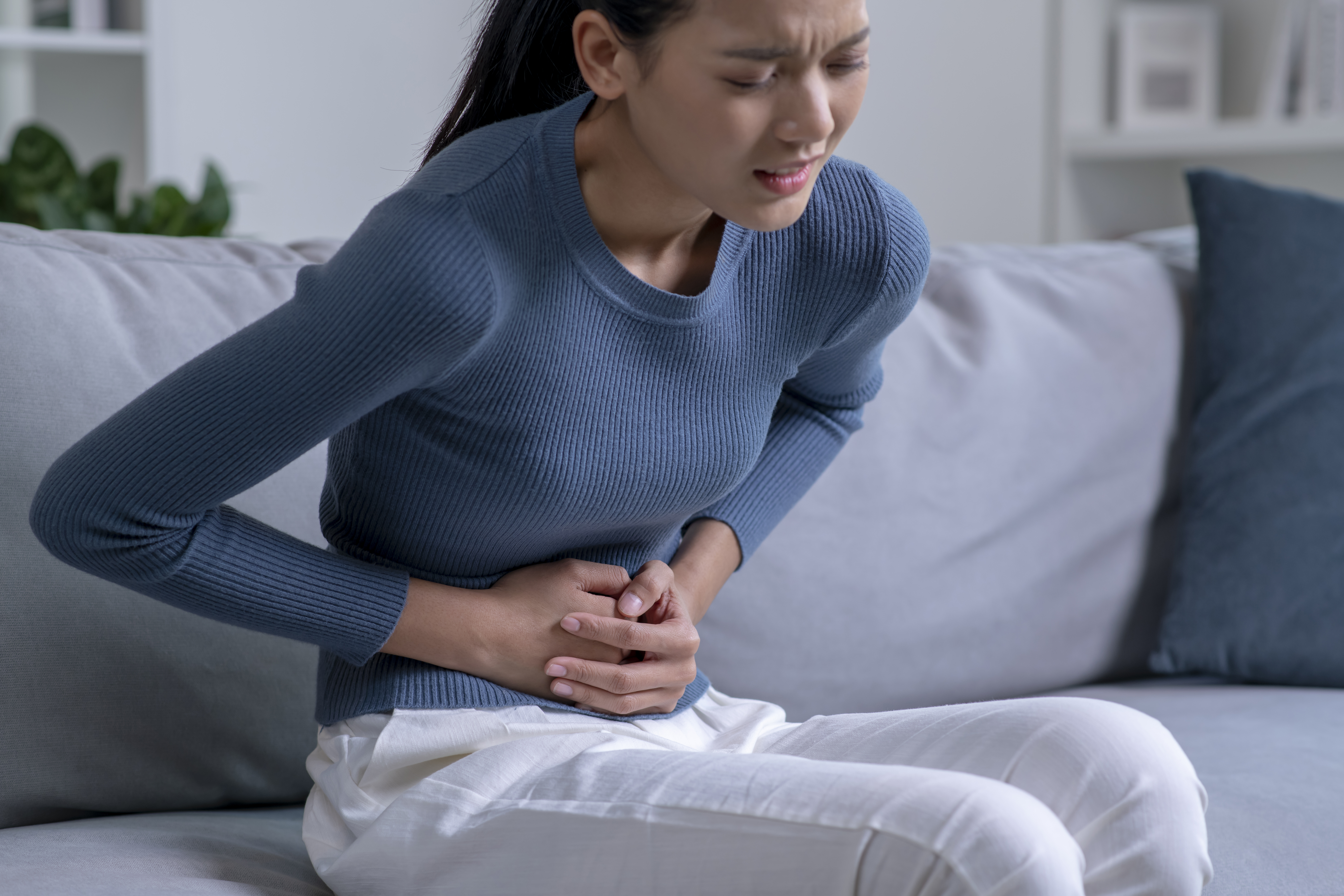 woman suffering from strong abdominal pain woman suffering from strong abdominal pain