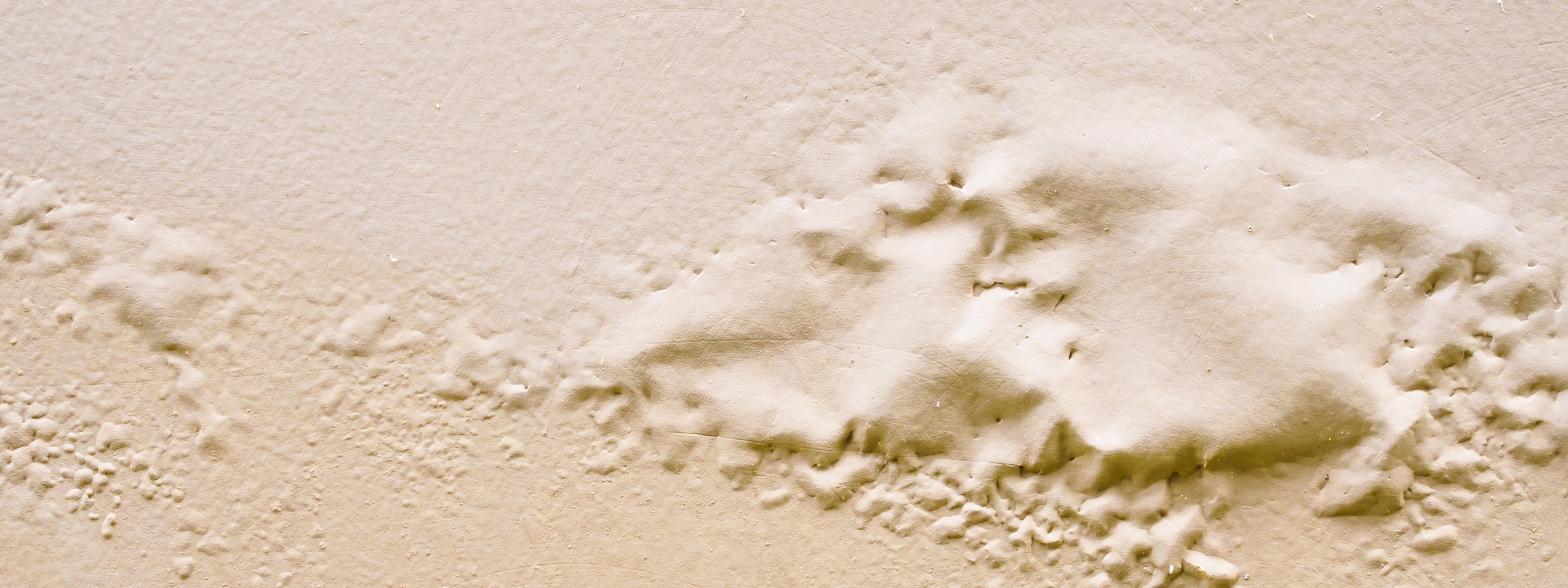 Water-damaged ceiling with bubbling and peeling paint, a common sign of hidden plumbing leaks that can lead to costly repairs and structural damage. Water-damaged ceiling with bubbling and peeling paint, a common sign of hidden plumbing leaks that can lead to costly repairs and structural damage.