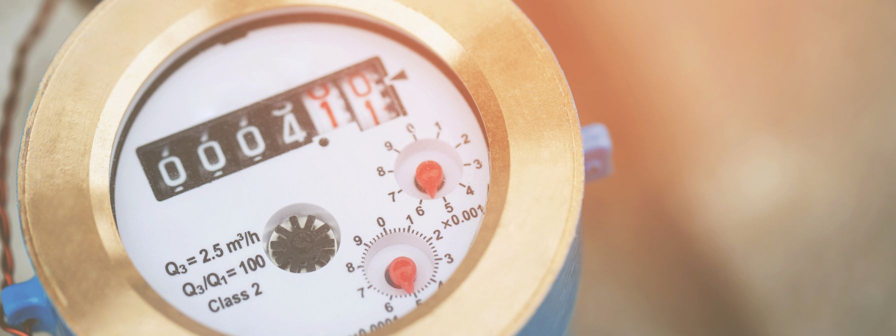 Close-up of a residential water meter with visible dials and digital readings—used to measure household water consumption and detect potential leaks or billing discrepancies.