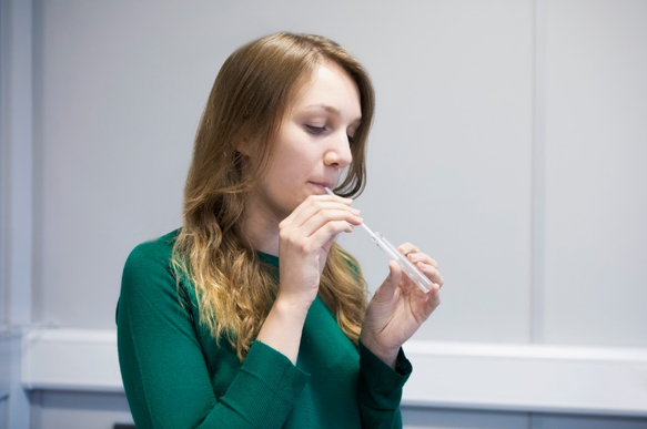 Patient blowing into test tube Patient blowing into test tube