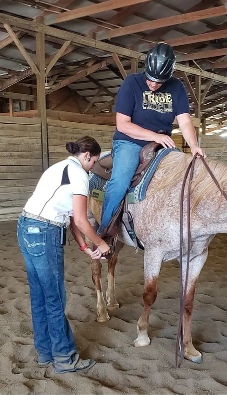 Amy Vanner measuring for proper stirrup length for a western dressage rider