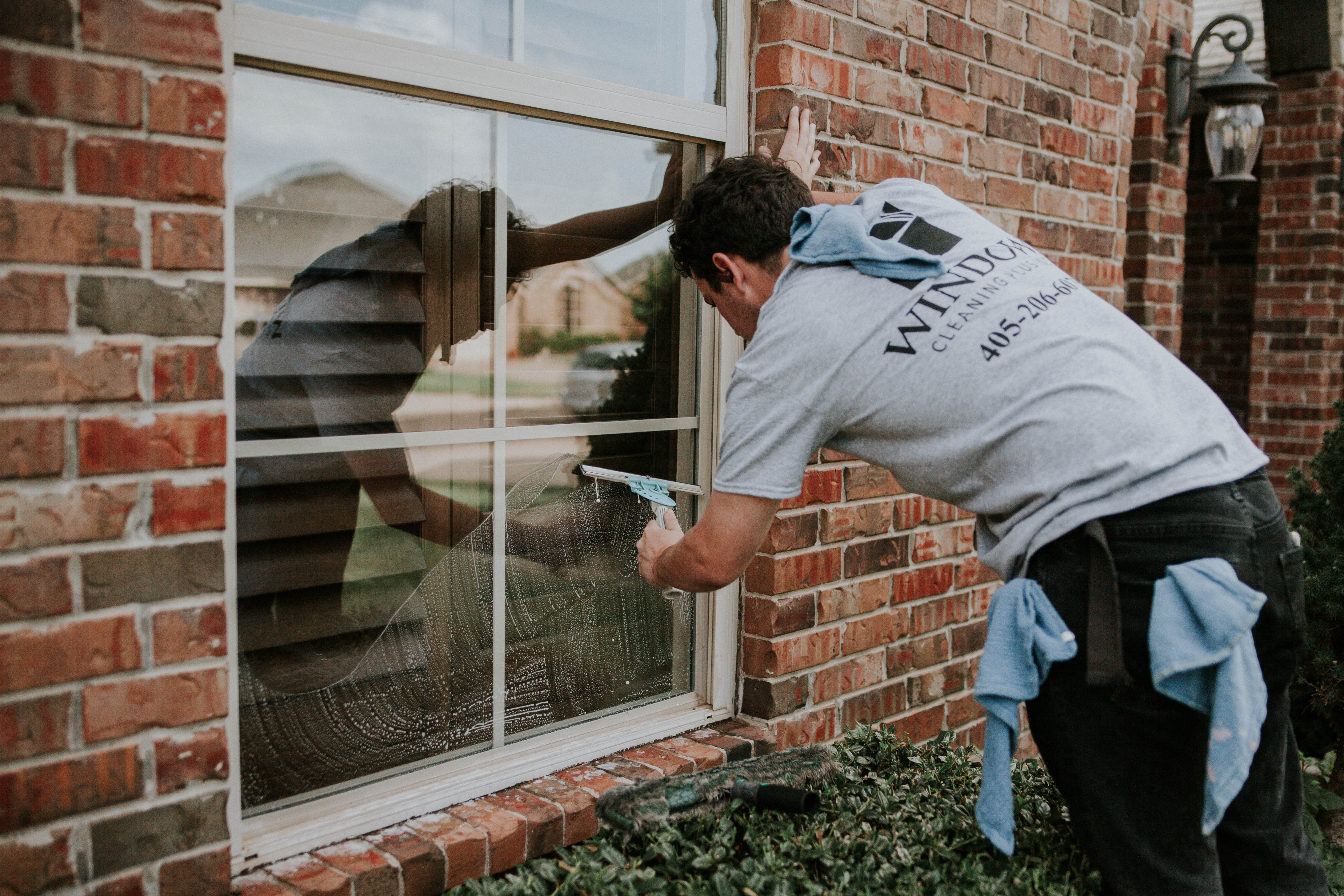 Window Cleaner, cleaning a window Window Cleaner, cleaning a window