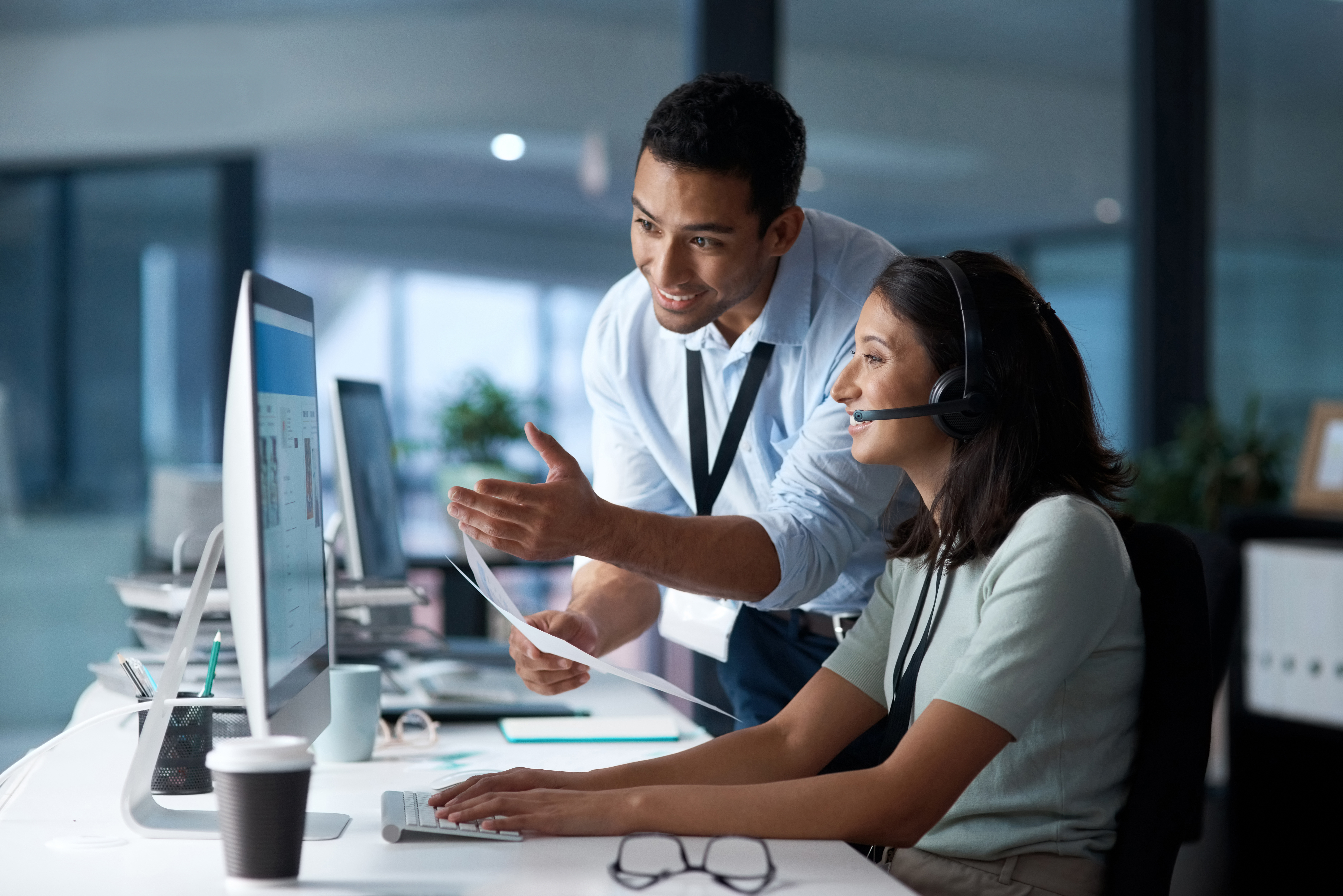 man helping woman with computer man helping woman with computer