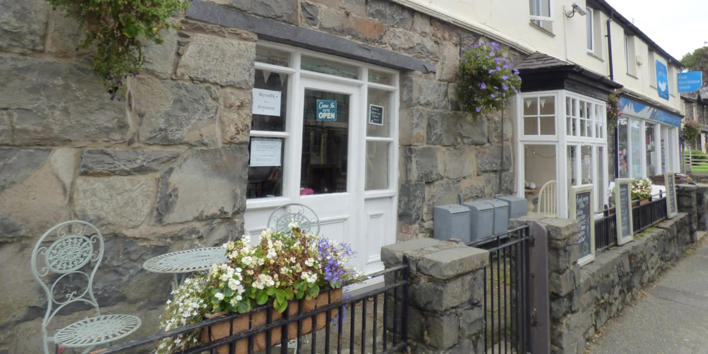 A cafe shopfront, with outside seating A cafe shopfront, with outside seating