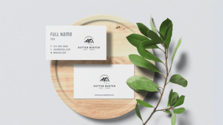 a wooden plate with a plant and 2 business cards