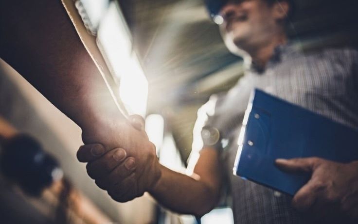 a person shaking hands with another person