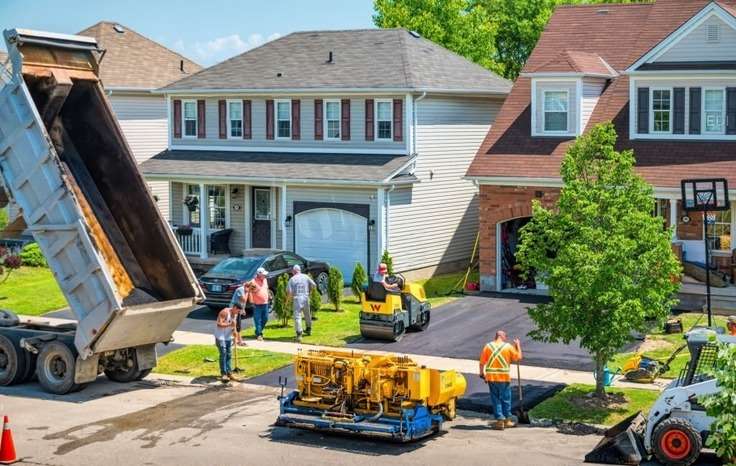 people paving a house's driveway