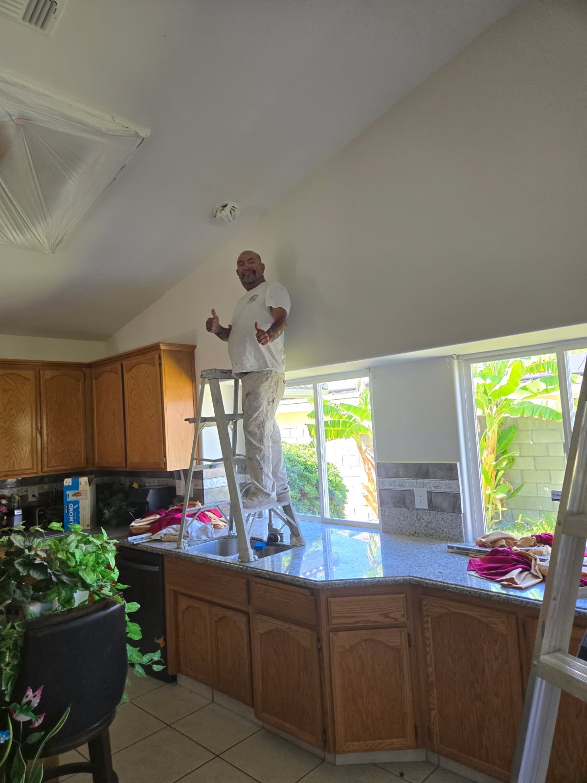 Owner painting inside kitchen area — prep & prime