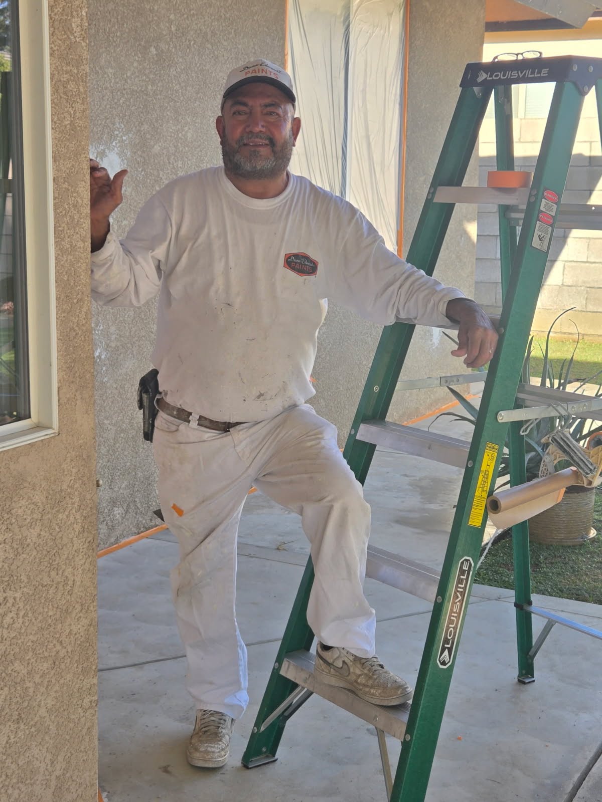 Master painter J. Gomez on site with ladder in Bakersfield