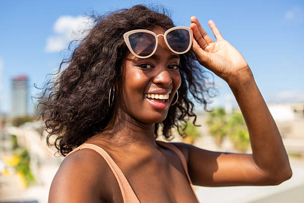 Black woman smiling confidently on vacation without makeup Black woman smiling confidently on vacation without makeup