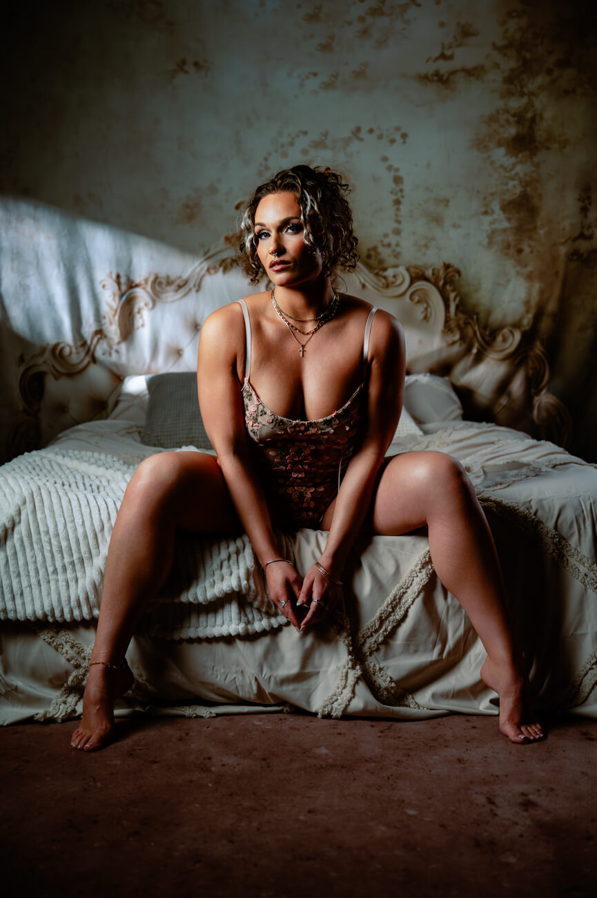women on edge of bed, boudoir session, confident women