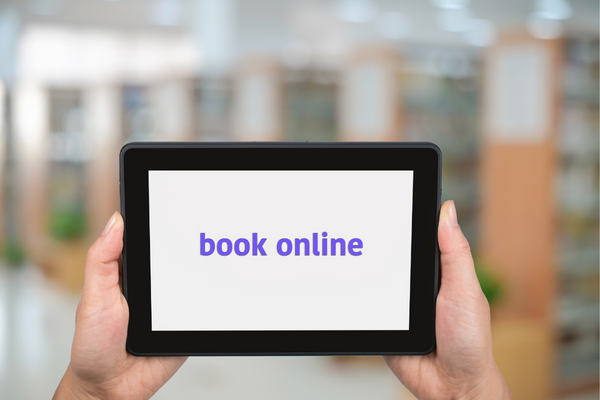 AN image of a tablet computer with the words "online booking" displayed.