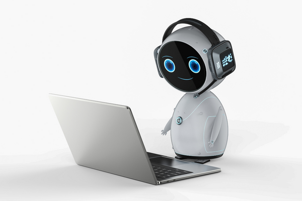 A cute robot responds to messages on a computer. 