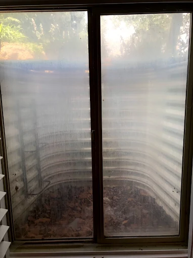 Before residential window cleaning in Orem Utah showing dirt buildup on glass4