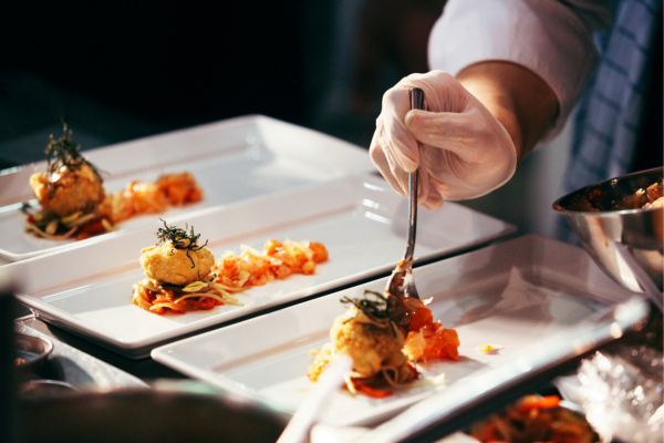 Chef plating food at a fine dining restaurant Chef plating food at a fine dining restaurant