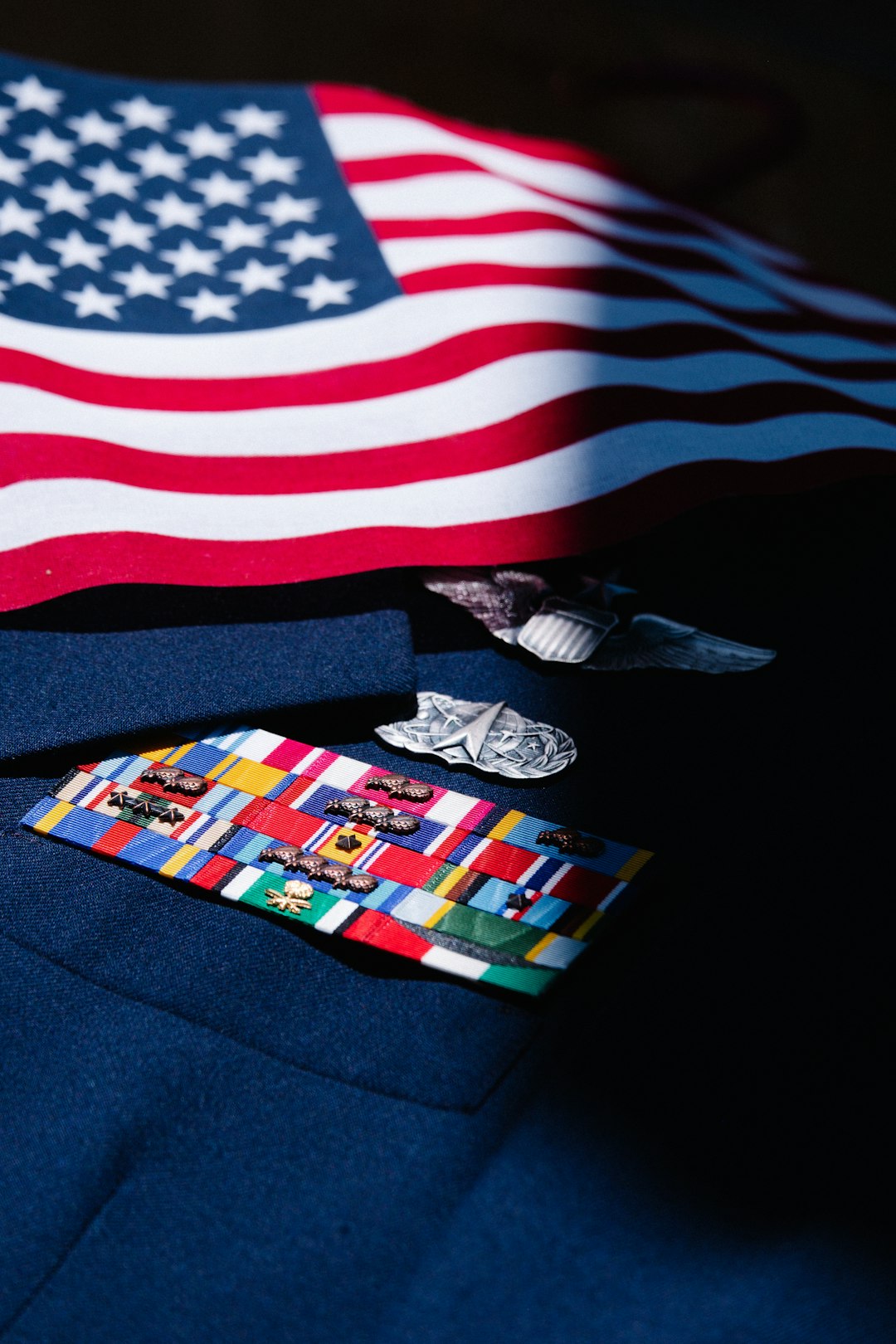 Veteran and lender reviewing VA loan eligibility documents in an office. Veteran and lender reviewing VA loan eligibility documents in an office.