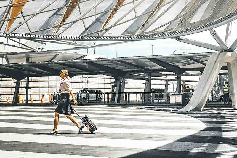 woman dragging luggage